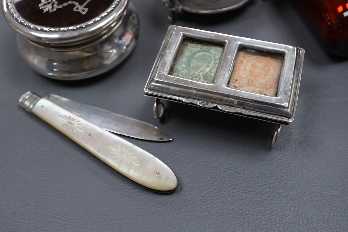 An Edwardian silver and tortoiseshell pique mounted trinket box, by William Comyns, London, 1905, diameter 59mm, together with one other George V trinket box on tripod feet, two mounted glass scent bottles, a Victorian m